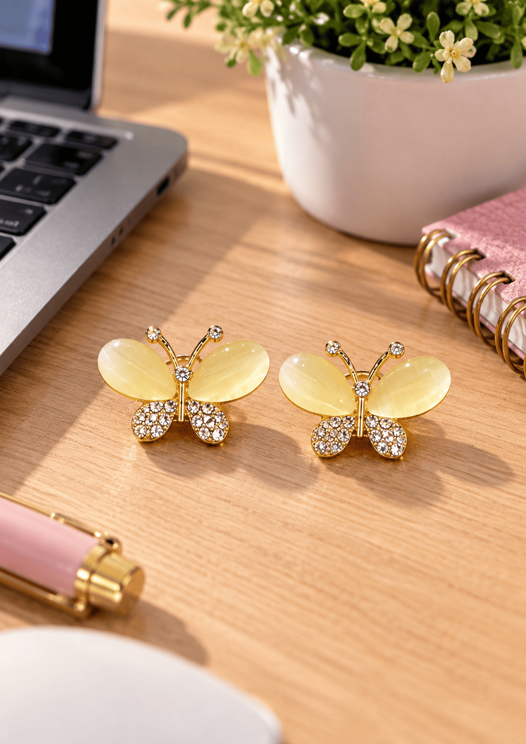 Golden Butterfly Drop Earrings for Women – Gold Tone 3 Gold-tone butterfly earrings displayed on a wooden table