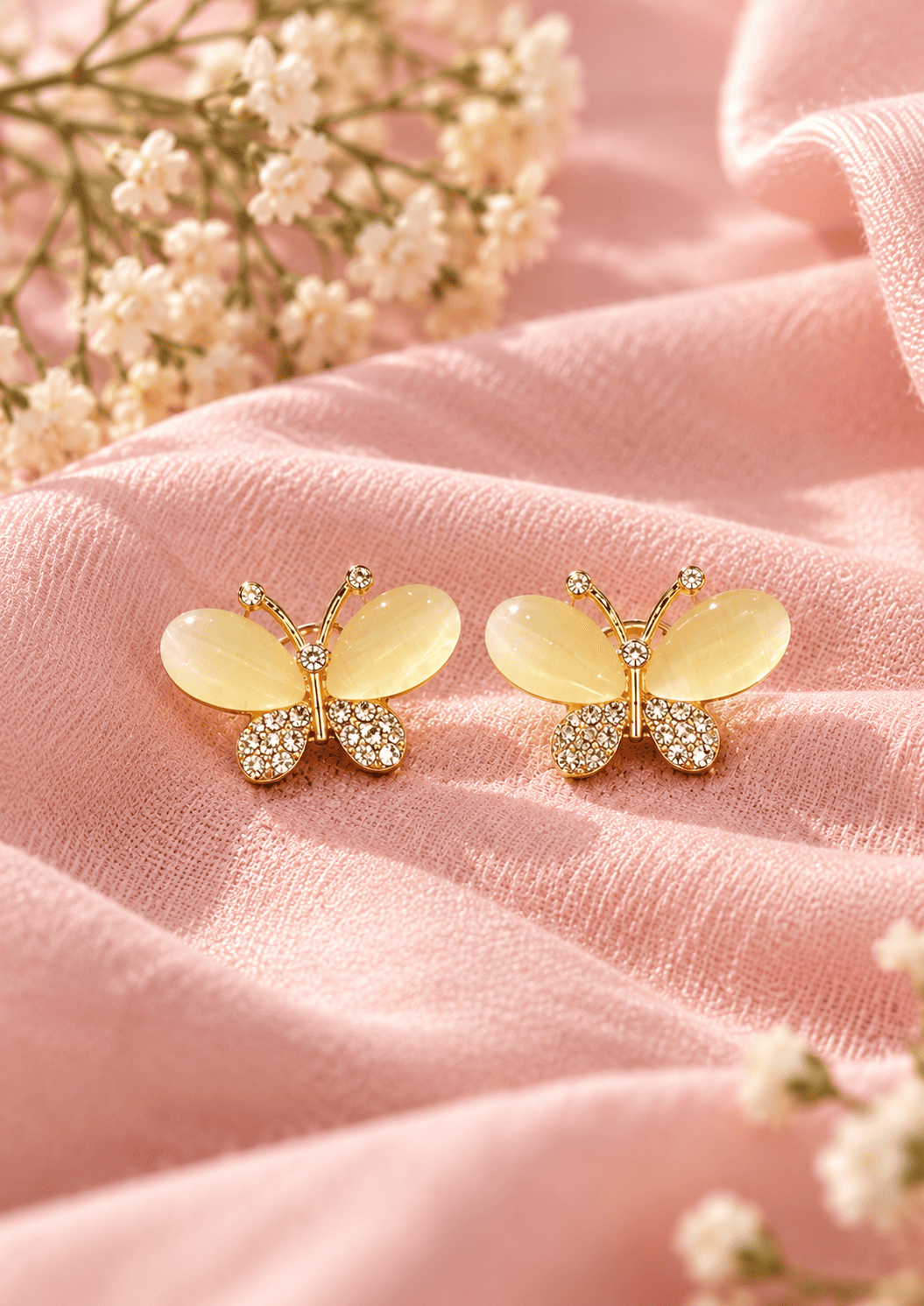 Golden Butterfly Drop Earrings for Women – Gold Tone 2 Golden butterfly earrings on soft pink fabric